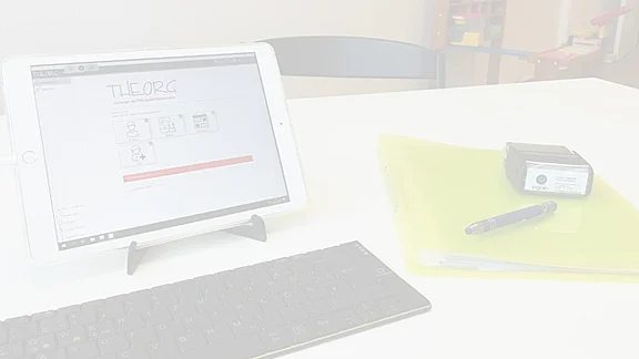 Ein Tablet und eine Tastatur liegen auf einem Schreibtisch.